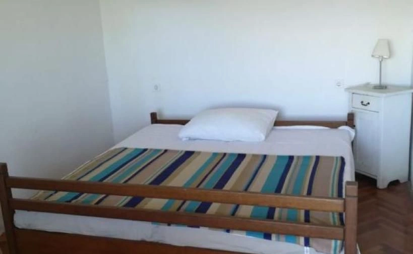 Casa de pedra à beira-mar com um terraço coberto