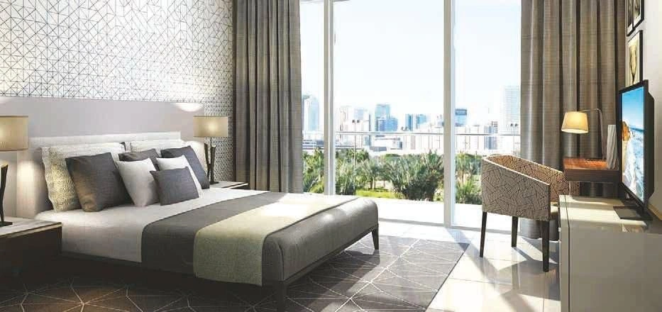 High-rise residential complex with swimming pool near Dubai metro station